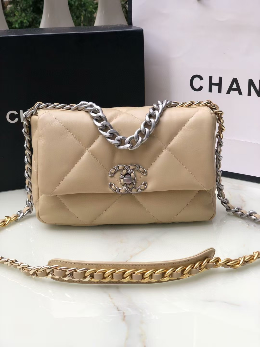 Ch*el 19 handbag shiny leather, gold-tone, silver-tone & ruthenium-finish metal beige 26x16x9cm