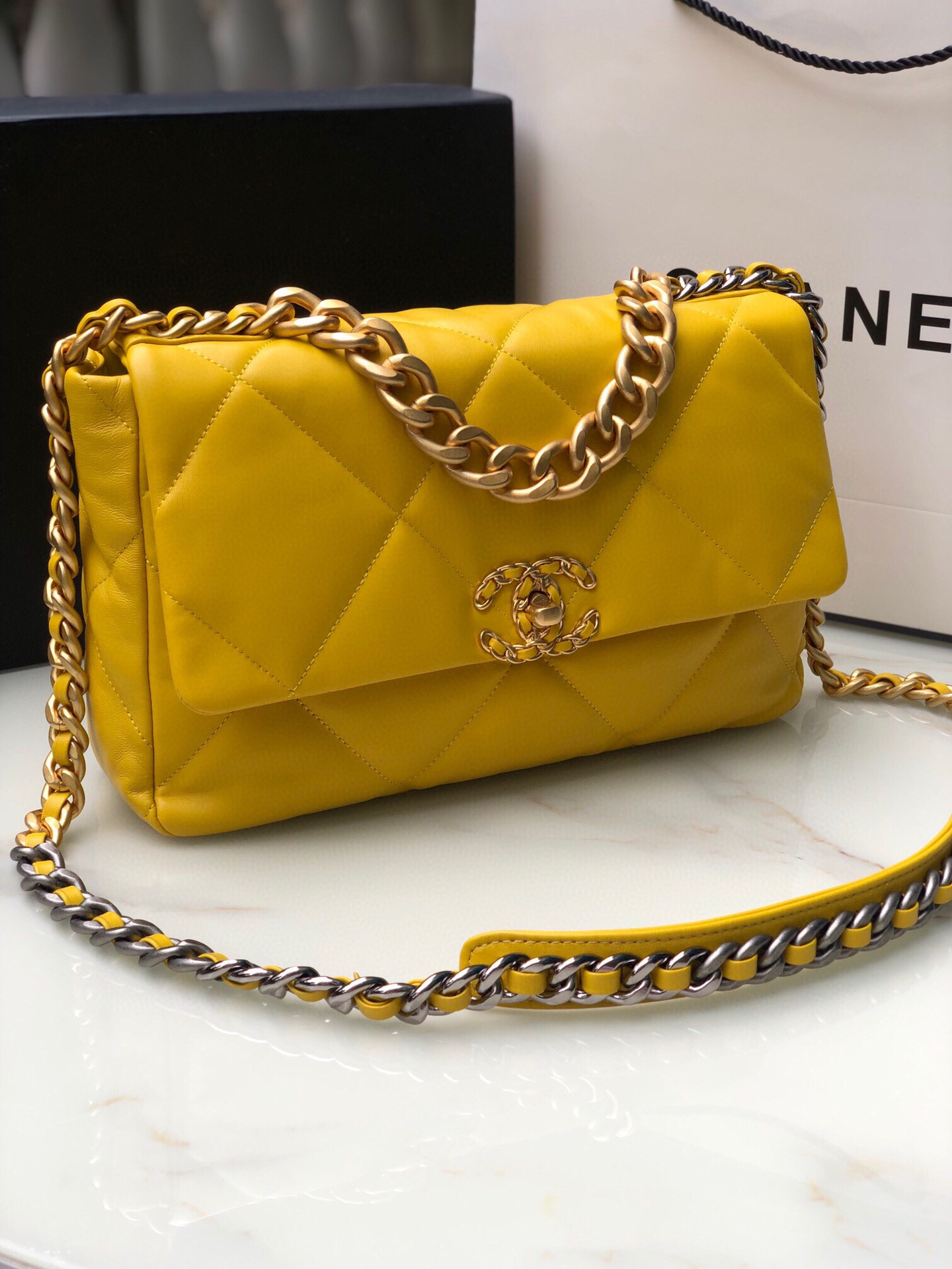 Ch*el 19 large handbag shiny leather, gold-tone, silver-tone & ruthenium-finish metal yellow 7.8 × 11.7 × 3.9 in