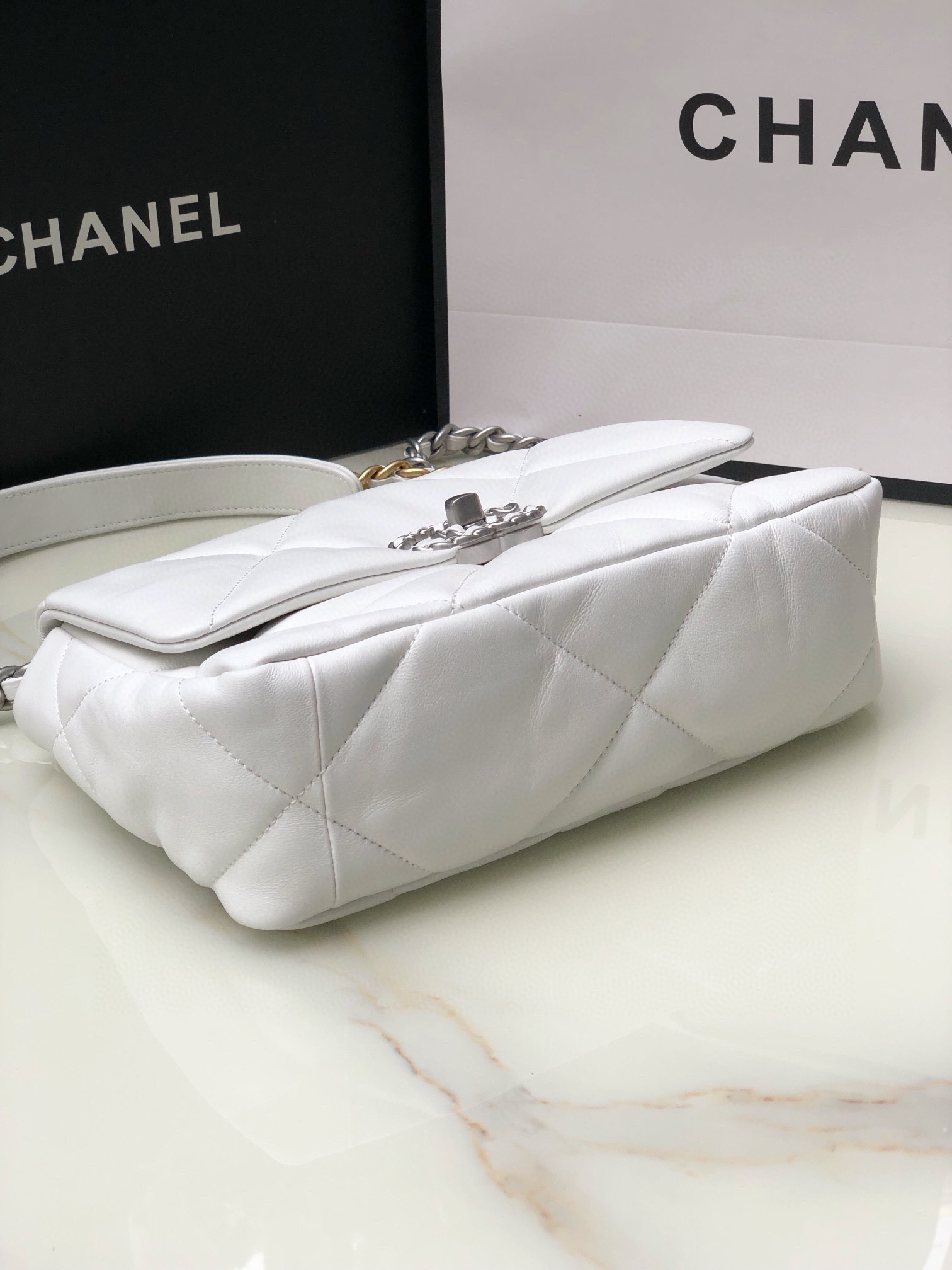 Ch*el 19 handbag shiny leather, gold-tone, silver-tone & ruthenium-finish metal white 6.2 × 10.1 × 3.5 in